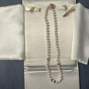 18 inch rose colored cultured  pearls6 1/2 to 7 mm pearls. 4 rondels of Rubies.